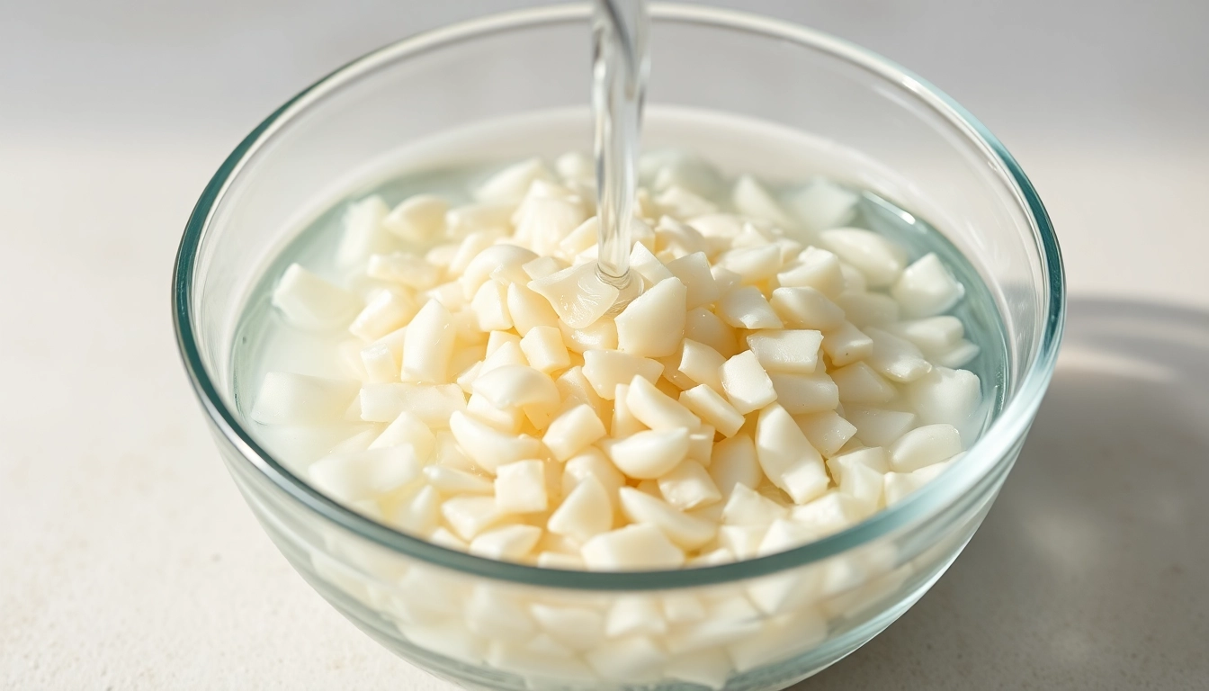 Close-up of minced garlic in water being poured into a bowl, showcasing freshness and quality